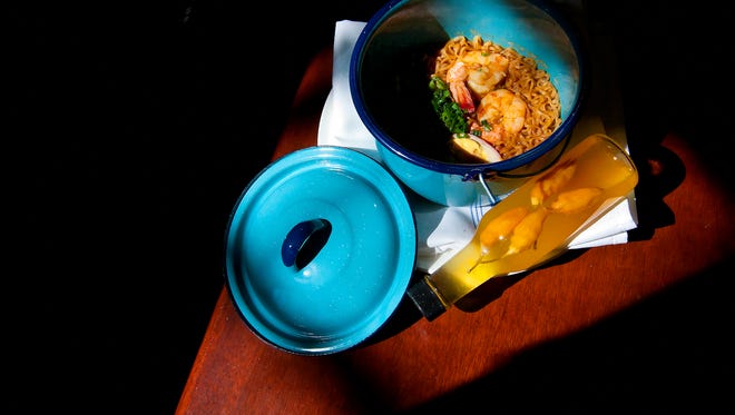 Blue steam pots cradle St. Augustine Stew, served with house-made Datil pepper vinegar.