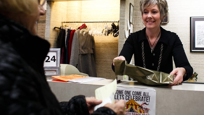 Style Works owner Sherri Windecker rings up customer Karla Hoffman at her shop along Washington Ave on Tuesday, November 24, 2015 in Iowa Falls. Hoffman has been shopping at the store for over 18 years.