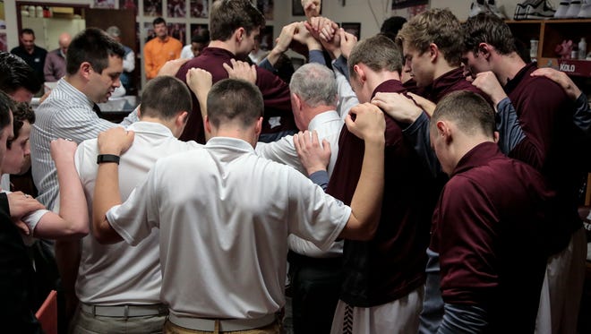 Bellarmine players and head coach Scott Davenport say a prayer before playing playing the University of Indianapolis, Sat., Jan. 30, 2016, at Bellarmine's Knights Hall in Louisville, Ky.