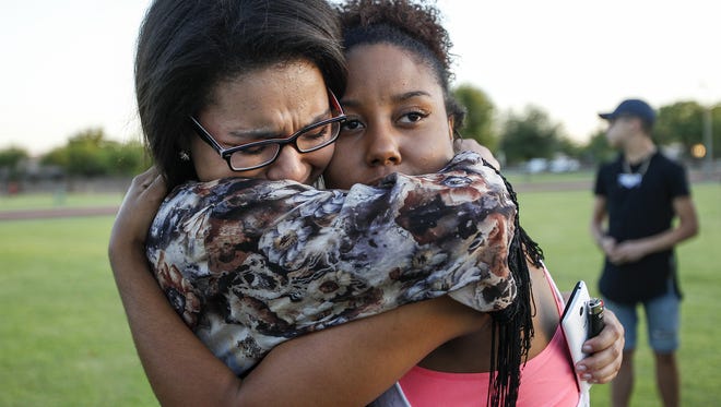 Alexis Shaffer-lopz, 18, from Mesa hugs Armonee Jackson, 18, from Mesa at a vigil to remember Jason Josaphat at Skyline Park in Mesa on June 15, 2016