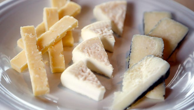 An all-Iowa cheese plate from The Cheese Shop features Prairie Breeze from Milton Creamery, Robiola di Mia Nonna from Reicherts Dairy Air, and Bootleg from Doe's and Diva's.