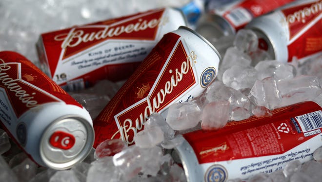 FILE - In this Thursday, March 5, 2015, file photo, Budweiser beer cans are on ice at a concession stand at McKechnie Field in Bradenton, Fla. On Wednesday, Sept. 28, 2016, it was announced that Budweiser maker Anheuser-Busch InBev will pay $6 million to the Securities and Exchange Commission to settle charges that the company made improper payments to government officials in India to promote its products and then tried to hush an employee who reported the violations. (AP Photo/Gene J. Puskar, File)