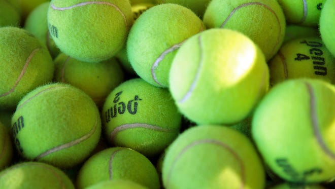 Practice tennis balls are in a bucket at Plaza Racquet Club in Palm Springs, Calif. on March 5, 2015.