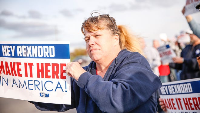 Employees of Rexnord Bearings in Indianapolis, local union reps and family members of the employees protest Rexnord's decision to likely move 300 jobs to Mexico on Nov. 11, 2016. 