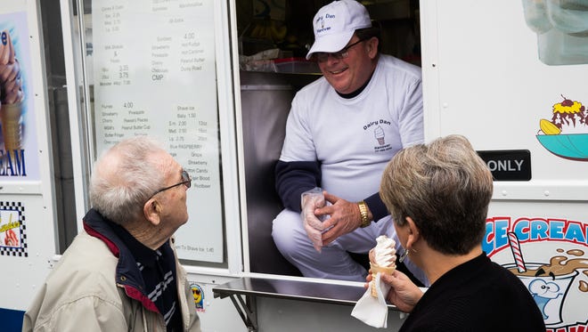 The new owner of Dairy Dan of Hanover, Joe Rife, serves ice cream to the first owner of Dairy Dan, Charles Helwig and his daughter, Sharon Crook.