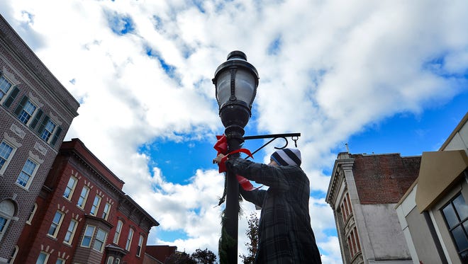 Downtown Inc. and their volunteers decorate lamp posts in downtown York during the 16th annual Hanging of the Greens, Sunday, Nov. 19, 2017.   John A. Pavoncello photo