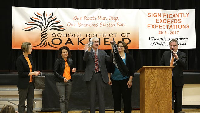 State Superintendent of Public Instruction Tony Evers holds up gifts from the Oakfield School District after speaking at an assembly which celebrated Oakfield as significantly exceeding expectations for the 2016-2017 school year. From left to right are Carmen Klassy, Becky Doyle, Evers, Penny Kottke, and Superintendant Dr. Vance Dalzin. Doug Raflik/USA TODAY NETWORK-Wisconsin