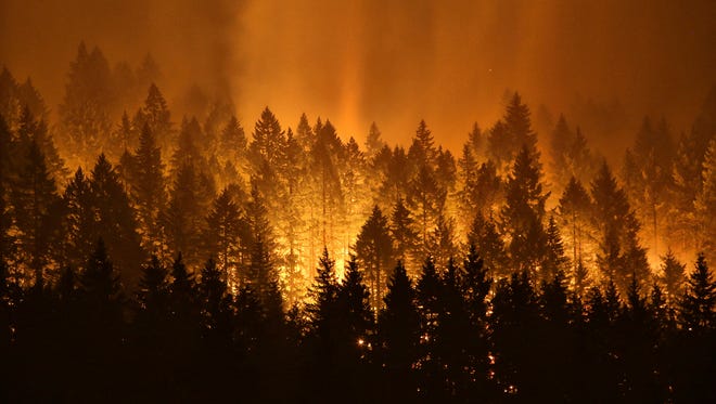 In this Sept. 5, 2017, file photo, the Eagle Creek wildfire burns on the Oregon side of the Columbia River Gorge near Cascade Locks, Ore. A teenager started the major wildfire.
