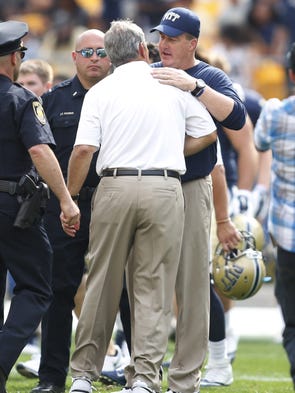 Iowa Hawkeyes head coach Kirk Ferentz (L) and Pittsburgh Panthers head coach Paul Chryst (R) meet at mid-field after playing at Heinz Field. The Hawkeyes won 24-20.