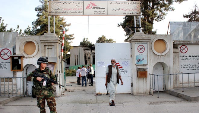 In this Oct. 15, 2015, file photo, an Afghan National Army soldier stands guard at the gate of a Doctors Without Borders hospital in Kunduz, Afghanistan. About 16 U.S. military personnel, including a two-star general, have been disciplined for mistakes that led to the bombing of the civilian hospital in Afghanistan last year that killed 42 people.