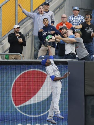 Kansas City Royals center fielder Lorenzo Cain leaps but can't reach the Yankees’ Brian McCann's first inning solo home run at Yankee Stadium in New York, Monday.