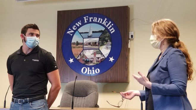 Summit County Councilwoman Bethany McKenny thanks New Franklin resident Doug Nist for his heroism during a New Franklin City Council meeting. On June 11, Nist jumped into the Tuscarawas River in Clinton and helped rescue a woman whose car went over an embankment and into the river.