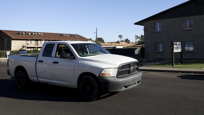 Police monitor the area around the Monte Vista apartment complex where an armed-robbery suspect fled after stealing a white pickup truck on March 6, 2018 in Phoenix. According to police the suspect's parents lived at the complex.