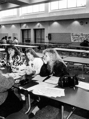 West High School marketing teacher Phyllis Jarboe, left, works with West High School students, sophomore Denise Saylor, left, and seniors Claudia Cook, center, and Brandy Burton in February 1992.