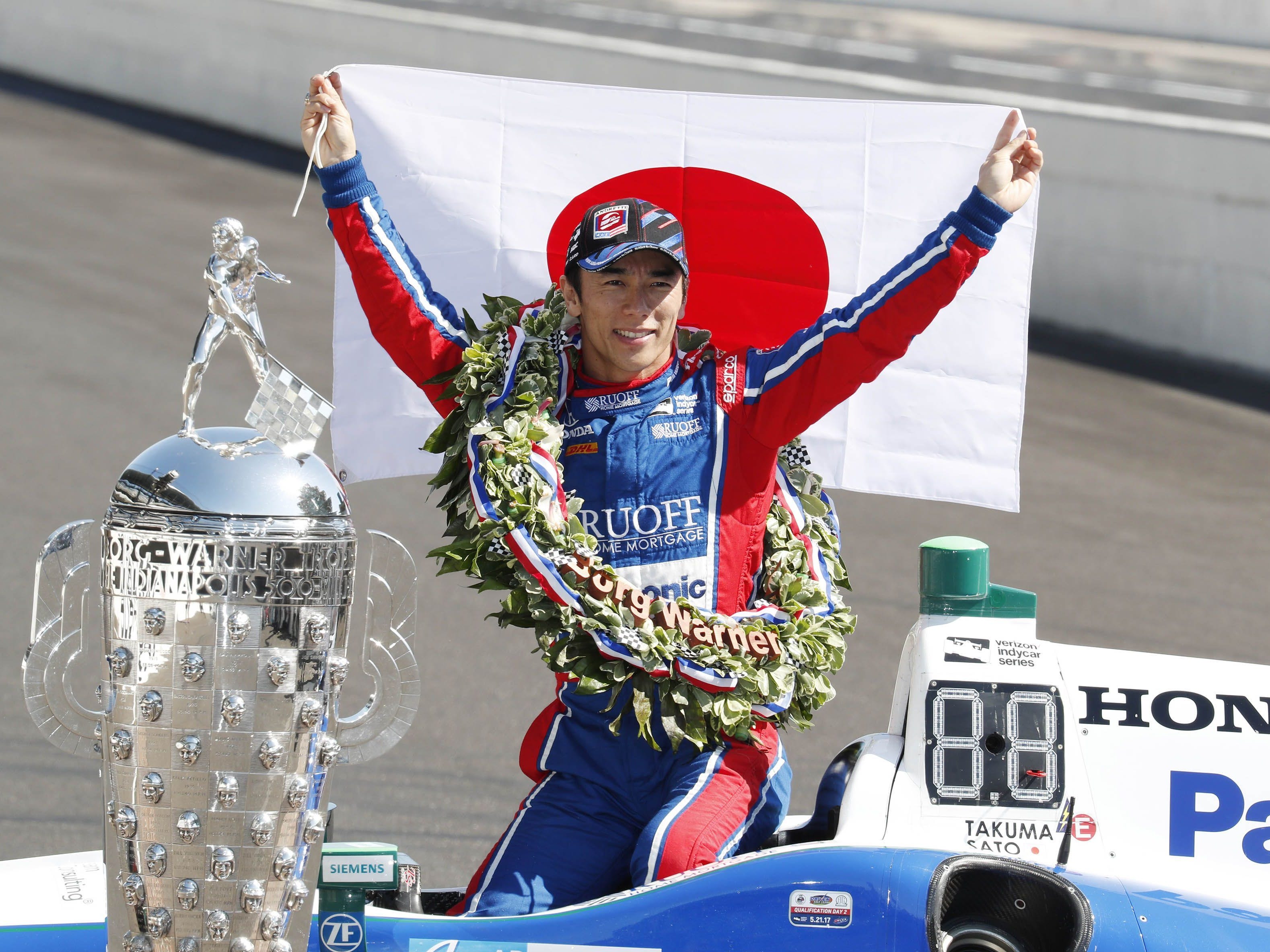Verizon IndyCar Series driver Takuma Sato holds up a Japanese flag after winning the 101st Running of the Indianapolis 500 at the Indianapolis Motor Speedway. Mandatory Credit: Brian Spurlock-USA TODAY Sports