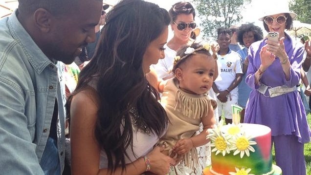 North West blows out her first birthday candle with parents Kim Kardashian and Kanye.
