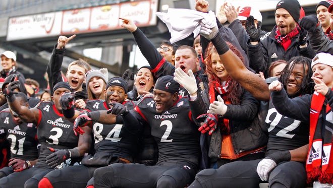 Bearcats players and fans celebrate the team's AAC co-championship.