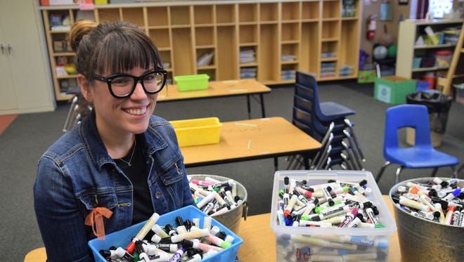 Dorothy Lemelson STEM Academy K-12 teacher Tobi Waldron holds a tub of Expo markers she collected for the #ArmMeWith campaign.