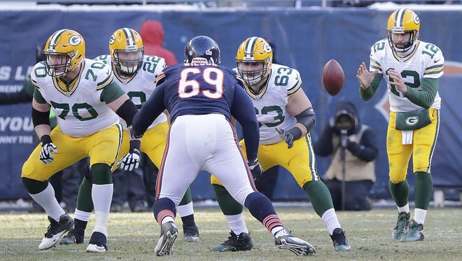 Green Bay Packers quarterback Aaron Rodgers (12) takes the snap as center Corey Linsley (63), fullback Aaron Ripkowski (22) and guard T.J. Lang (70) block against the Chicago Bears at Soldier Field.