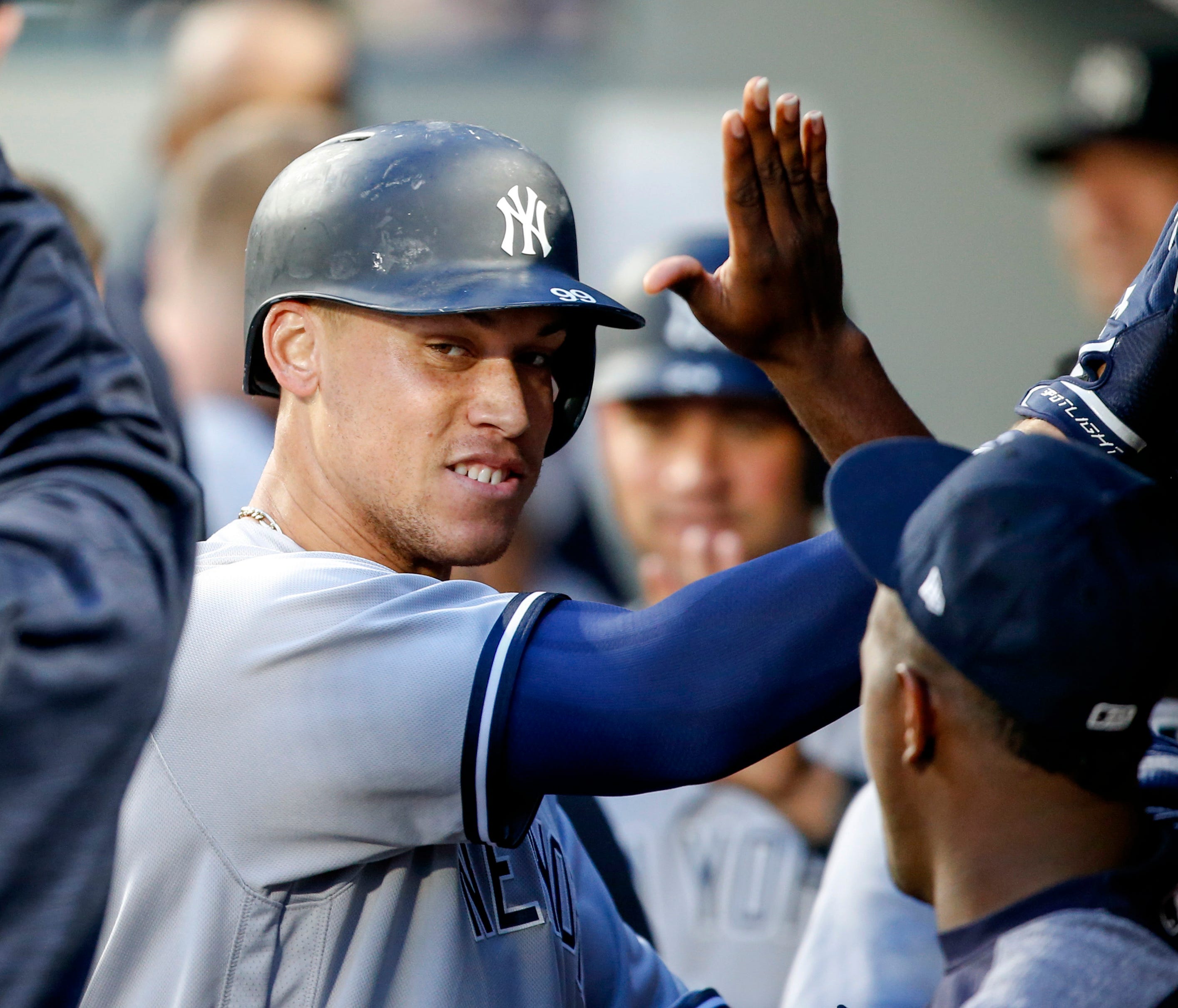 Jul 21, 2017; Seattle, WA, USA; New York Yankees right fielder Aaron Judge (99) exchanges high fives in the dugout after hitting a three-run homer against the Seattle Mariners during the fifth inning at Safeco Field. Mandatory Credit: Joe Nicholson-U