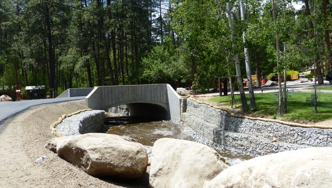 Water flows down the Rio Ruidoso under the new First Bridge on Main Road, the entrance to Upper Canyon Ruidoso. The road is paved and the bridge is on track to meet a May 21 completion date.