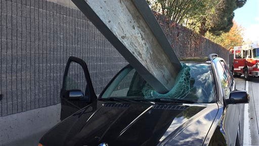 This Friday, Dec. 11, 2015 photo provided by the San Jose Fire Department shows a beam that fell off of a flatbed truck that impaled the window of a BMW car on I-280 in San Jose, Calif. The driver of the BMW, Don Lee, suffered only a small scratch to his right arm.