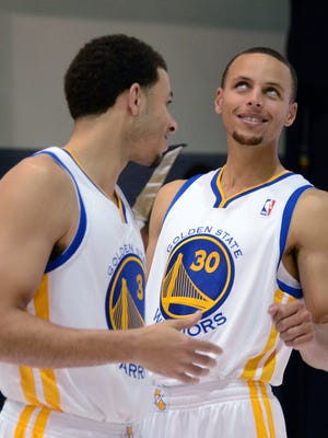 Golden State Warriors shooting guards Seth Curry and Stephen Curry joke during media day at the Warriors Practice Facility.