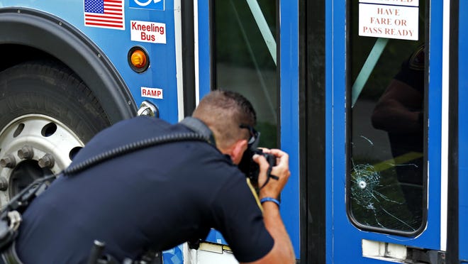Springfield Police respond to the scene where a City Utilities bus was hit with a bullet shot during a nearby altercation in Springfield, Mo. on July 2, 2015.