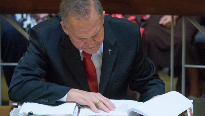Embattled Alabama Chief Justice Roy Moore looks over evidence during his ethics trial at the Alabama Court of the Judiciary at the Alabama Judicial Building in Montgomery, Ala., on Wednesday September 28, 2016.