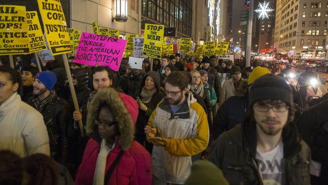 Anti-NYPD protesters march through Midtown Manhattan on Monday in New York City.