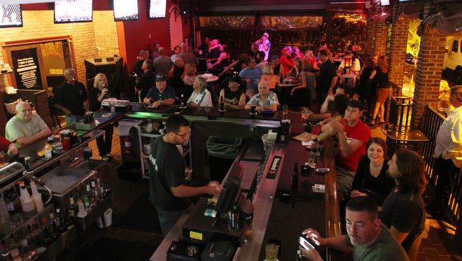 Patrons of Backstreats Sport Bar in Cape Coral sit out on the patio while watching basketball and singing karaoke. On Tuesday, the Community Redevelopment Agency discussed extending bar hours in its boundaries.