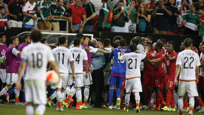 Players from Panama and Mexico scuffle following a late penalty kick call.