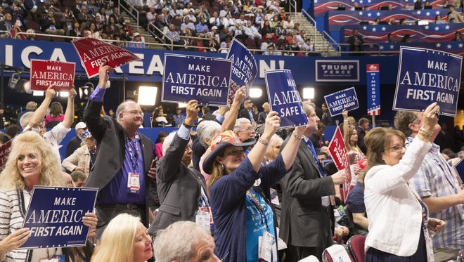 Arizona delegates cheer on the floor during Mike Pence's speech at the Republican National Convention in Cleveland on July 20, 2016.