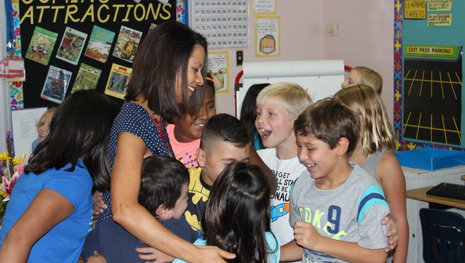 Bernadine Cotton’s third-grade class congratulates their teacher Tuesday, Aug. 23, 2016, at a surprise recognition ceremony at Tombaugh Elementary School. Cotton was recently named a recipient of the Presidential Award for Excellence in Mathematics and Science Teaching and she will be honored at a ceremony in Washington, D.C., on Sept. 8. She is one of only two awardees in New Mexico.