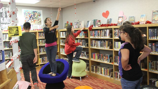 Students volunteered at the Carlsbad Public Library to decorate for "Love Your Library" month, which helps promote and show appreciation the library.