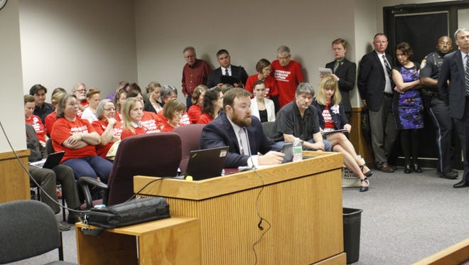 Rep. Jered Taylor, R-Nixa, testifies Monday on behalf of his bill to eliminate numerous gun-free zones on Monday, April 10, 2017, in Jefferson City. Seated behind Taylor wearing red  T-shirts are volunteers with Moms Demand Action.