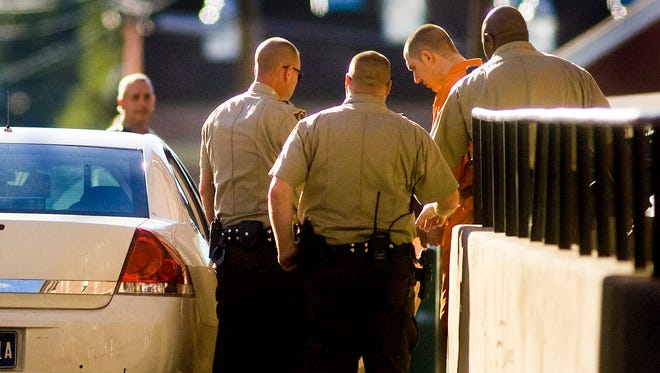 Adams County sheriff's deputies escort Christopher Johnson from the Adams County Courthouse in this file photo. Johnson was convicted of first-degree murder in the November 2010 shooting death of David Grove, a wildlife conservation officer.