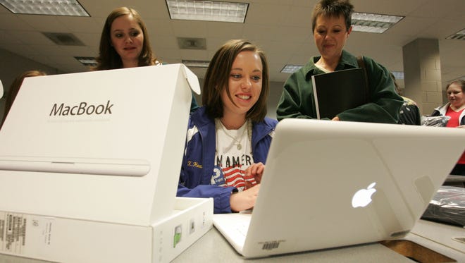 Thomas Wells
Tupelo seniors like Kelli Heath, 17, center, couldn't wait to get their hands on their new MacBooks Monday at the Performing Arts Center. For those seniors who didn't pick up their laptop they have two more chances Tuesday and Wednesday night from 5:15-6 at the Performing Arts Center and then on Saturday Feb. 13th there will be a Orientation and training at 9:30 a.m. in the cafeteria.