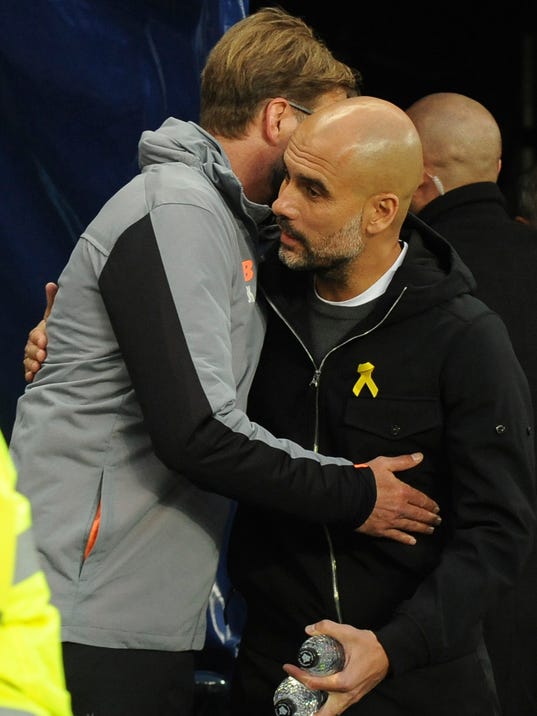 Liverpool manager Juergen Klopp, left, speaks with Manchester City manager Pep Guardiola before the Champions League quarterfinal second leg soccer match between Manchester City and Liverpool at Etihad stadium in Manchester, England, Tuesday, April 10, 2018. (AP Photo/Rui Vieira)
