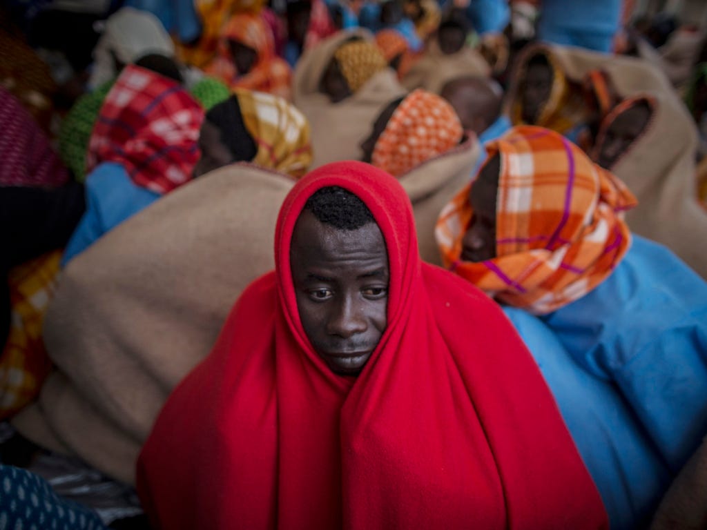 Refugees and migrants rest aboard the Golfo Azurro, the Spanish NGO Proactiva Open Arms rescue ship after being rescued off the Libyan coast. Rescuers found 332 people in three separate rubber boats traveling north of the Libyan coast, according to P