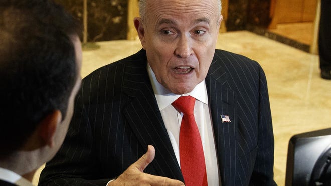 FILE - In this Jan. 12, 2017, file photo, former New York City Mayor Rudy Giuliani talks with reporters in the lobby of Trump Tower in New York. Giuliani's revelation that U.S. President Donald Trump reimbursed his personal attorney for a $130,000 payment to a porn star to keep her quiet about an alleged affair is raising new legal questions, including whether the president and his campaign violated campaign finance laws. Giuliani insisted on Fox News Channel Wednesday night, May 2, 2018, that the payment to adult film actress Stormy Daniels was "going to turn out to be perfectly legal." (AP Photo/Evan Vucci, File)