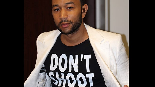 Singer John Legend shows Legend wearing a T-Shirt that says "Don't Shoot," in reference to the Aug. 9 shooting of Michael Brown in Ferguson, Mo., at the Hollywood Bowl in Los Angeles. Legend performed Marvin Gaye’s What’s Going on with the Los Angeles Philharmonic.
