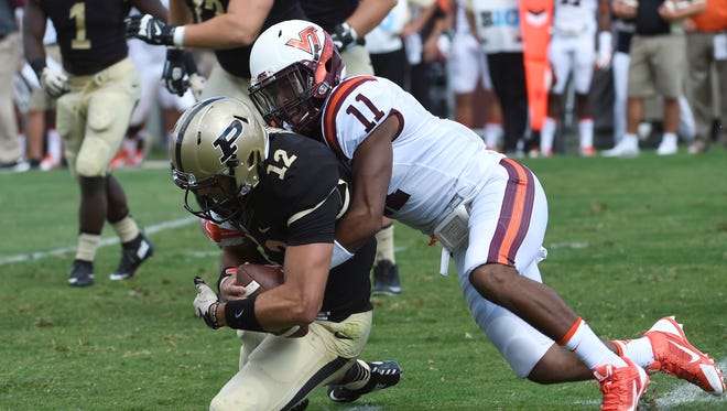 Kendall Fuller tackles Purdue quarterback Austin Appleby in their game Sept. 19.