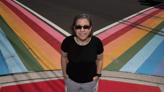 CJ Prince, Executive Director of North Jersey Pride, stands near rainbow painted crosswalks in Maplewood on Tuesday, June 19, 2018.