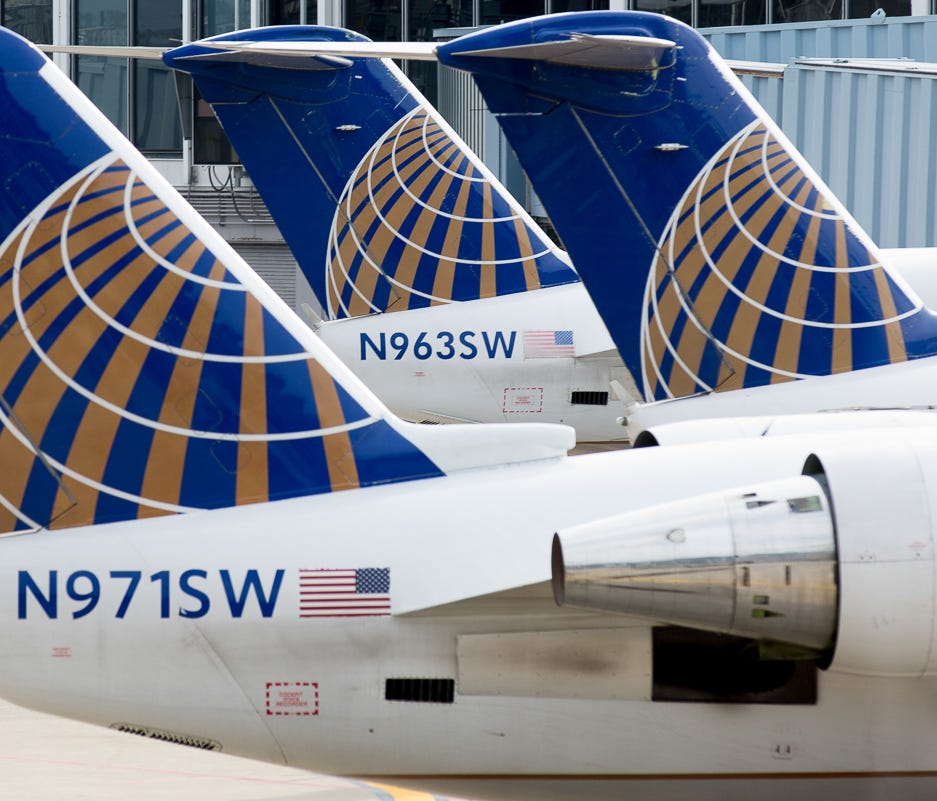 United Express tails line a terminal pier at Chicago O'Hare International Airport in April 2016.