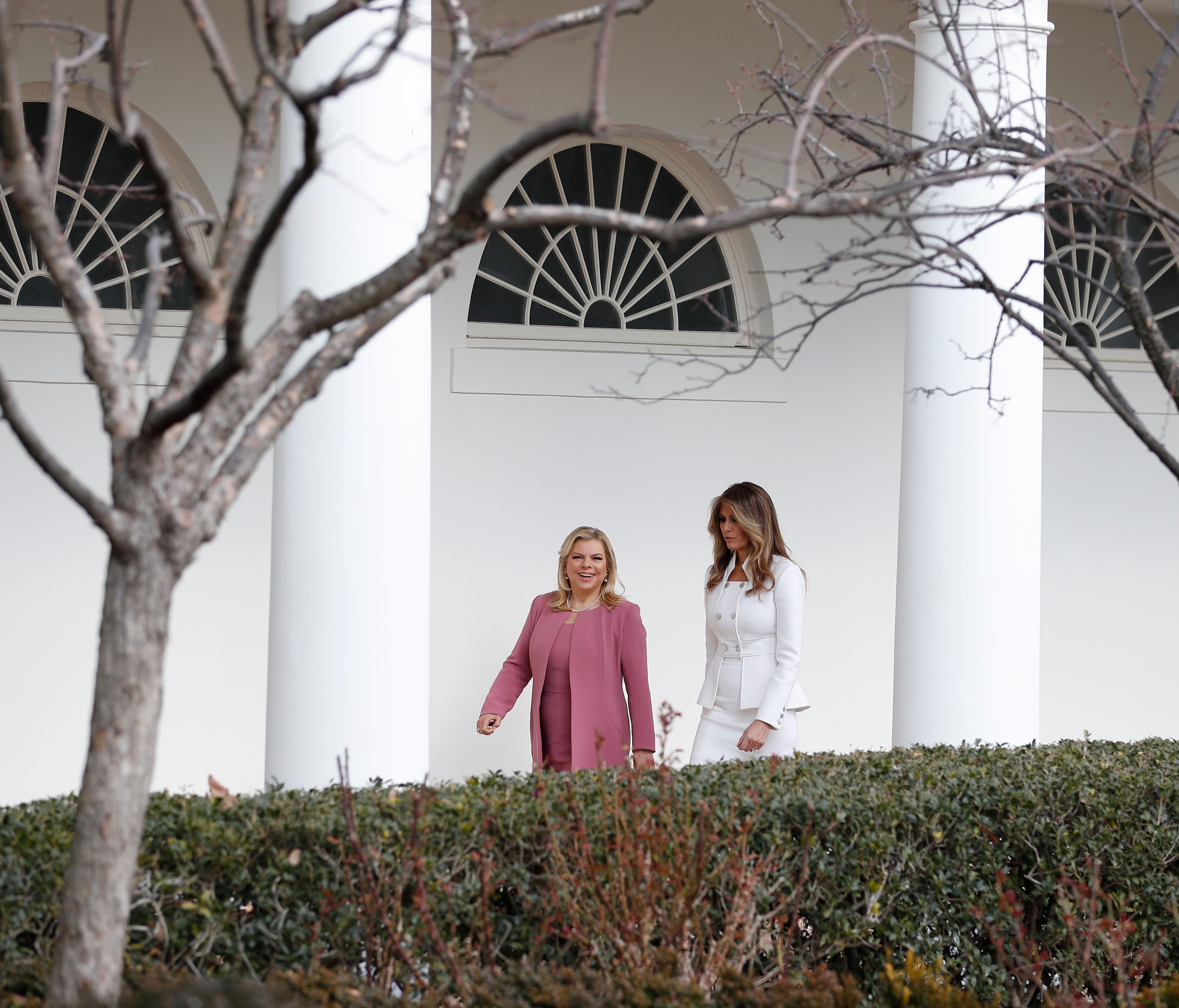 First lady Melania Trump and Sara Netanyahu, wife of Israeli Prime Minister Benjamin Netanyahu, walk along the colonnade of the White House in Washington.