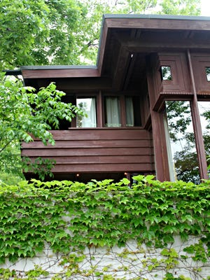 A view of the southwest side of the house, which includes a tiny bedroom with a deck.
