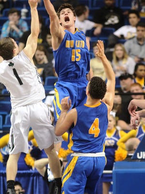 NCC senior Erik Anderson tries to block a shot Wednesday afternoon during NewCath's 48-33 win over Trinity.