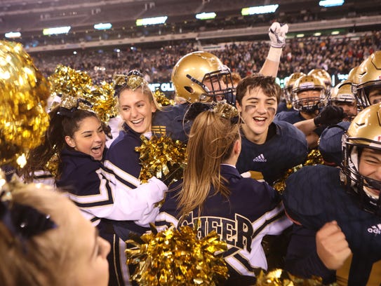 NV/Old Tappan cheerleaders and football players celebrate