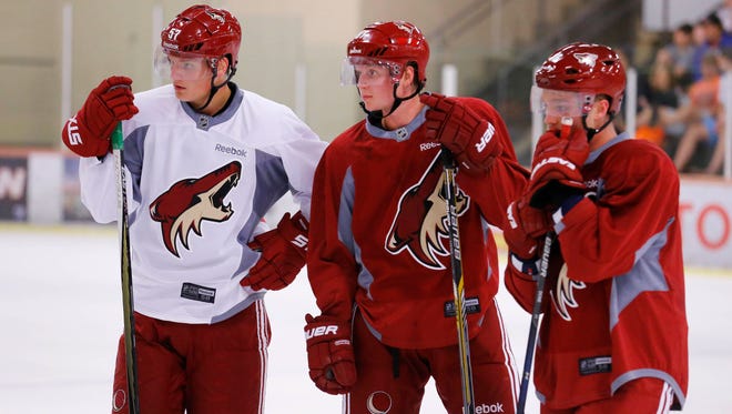 Arizona Coyotes' Anton Karlsson, Jens Looke, and Max Domi look on during their 2015 development camp on Tuesday, July 7, 2015, in Scottsdale.